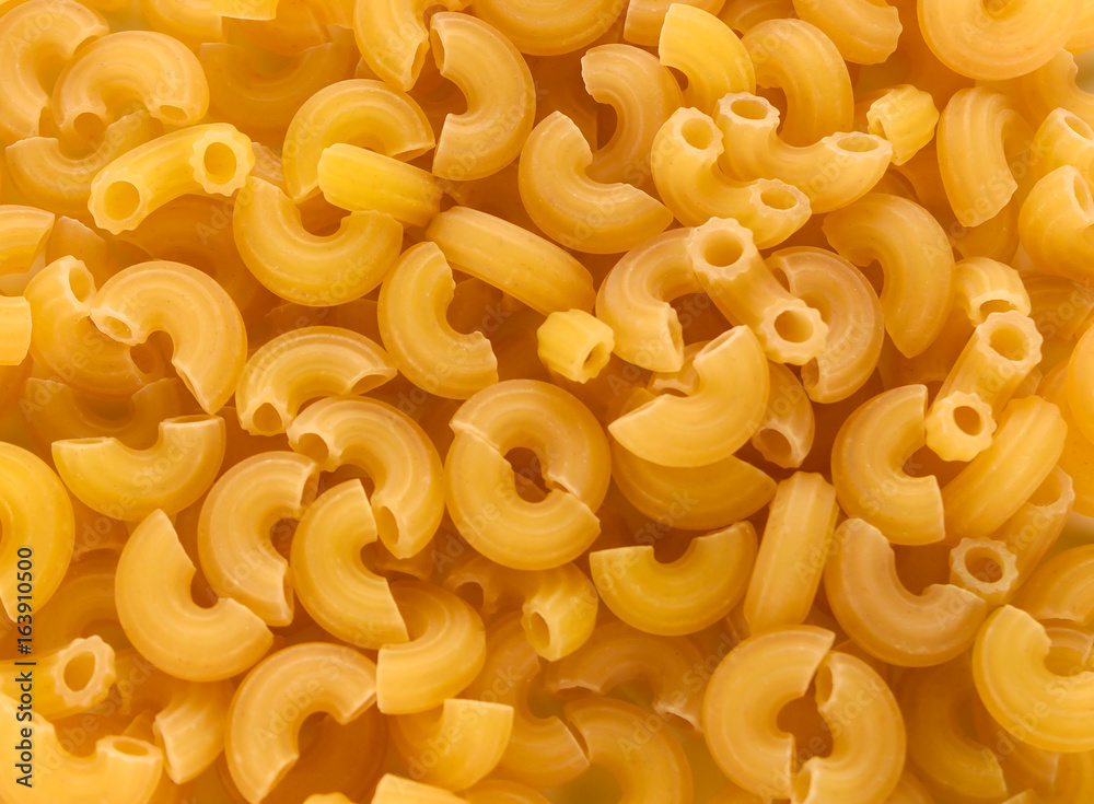 Dry uncooked macaroni pasta background Dry uncooked macaroni pasta background