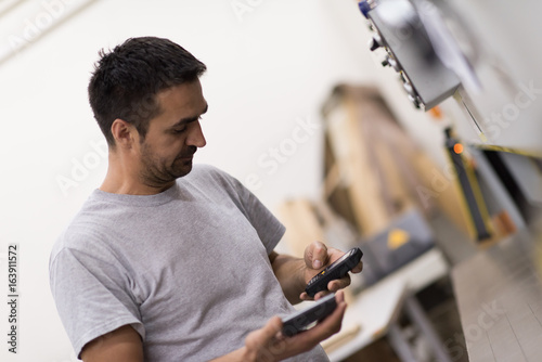 engineer in front of wood cutting machine