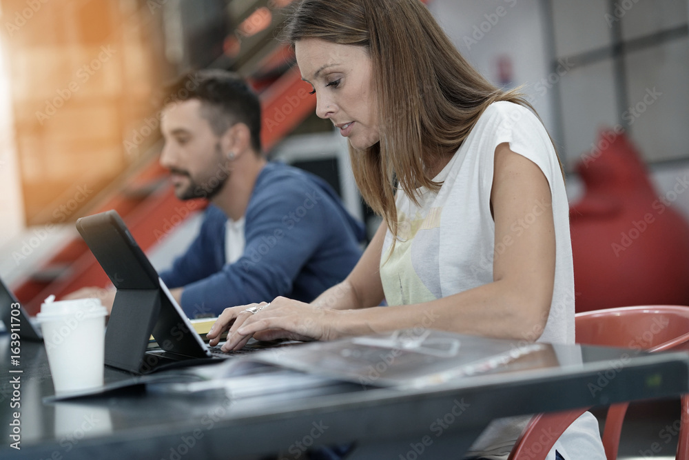 Trendy young people working in co-working office Trendy young people working in co-working office