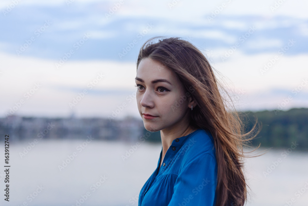 Summer happy portrait beautiful woman girl caucasian asian blended in blue shirt posing on background sky lake water sunset long hair brunette outdoors Summer happy portrait beautiful woman girl caucasian asian blended in blue shirt posing on background sky lake water sunset long hair brunette outdoors