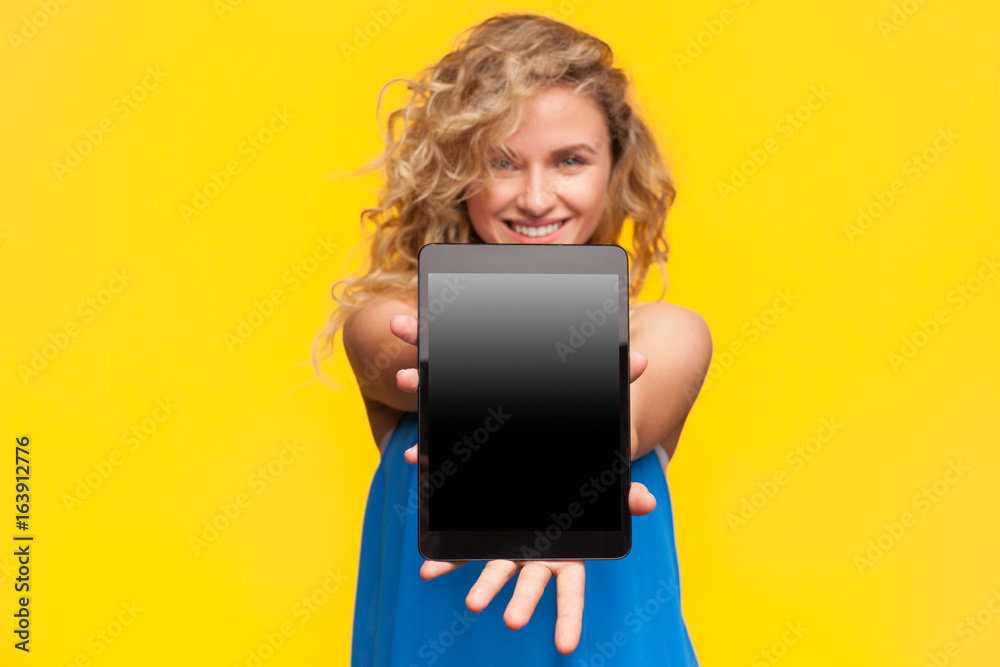 Smiling woman holding black device Smiling woman holding black device