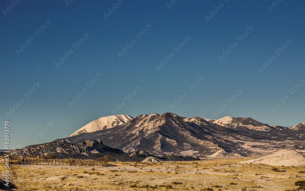 Mountain landscape with clear blue sky and a snow covered mountain