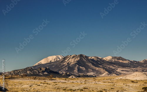 Mountain landscape with clear blue sky and a snow covered mountain