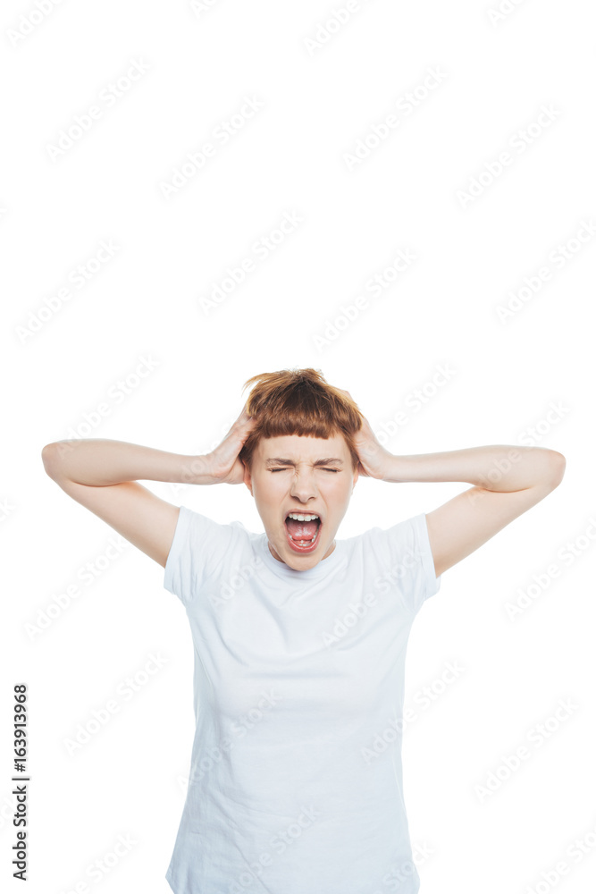 Stressed young woman with headache holding hands on head and screaming with closed eyes isolated on white Stressed young woman with headache holding hands on head and screaming with closed eyes isolated on white