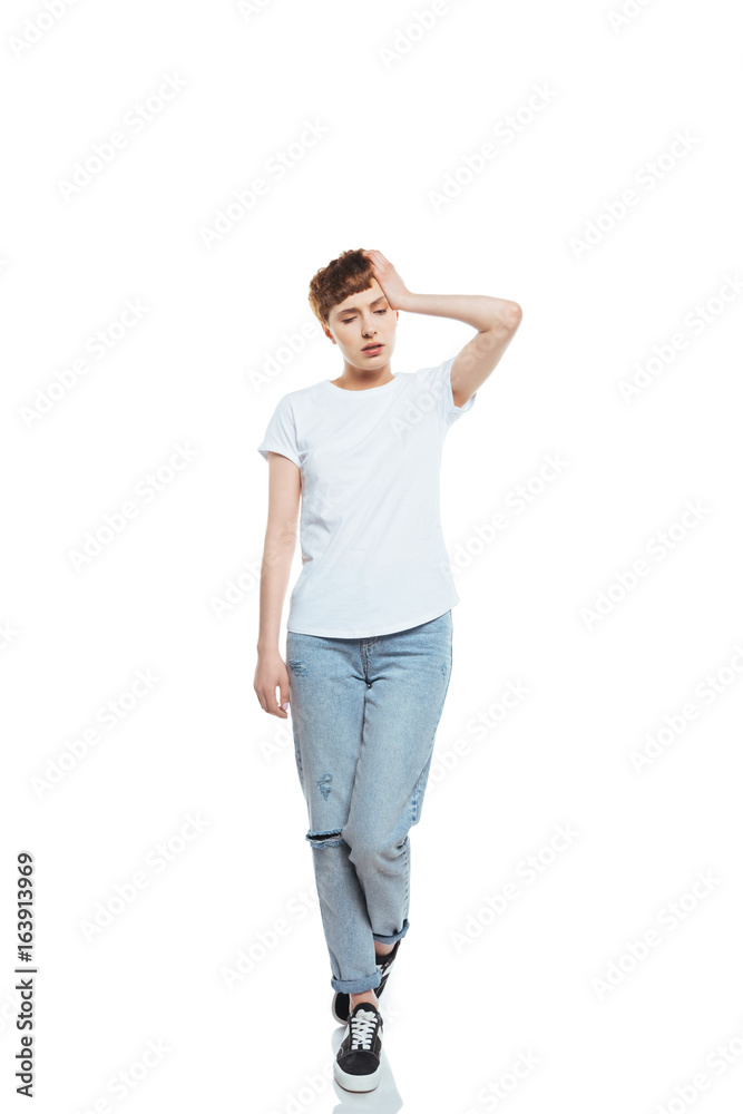 Tired young woman with headache holding hand on head isolated on white Tired young woman with headache holding hand on head isolated on white