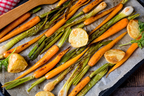 caramelised carrots, spring onions and baked potatoes photo