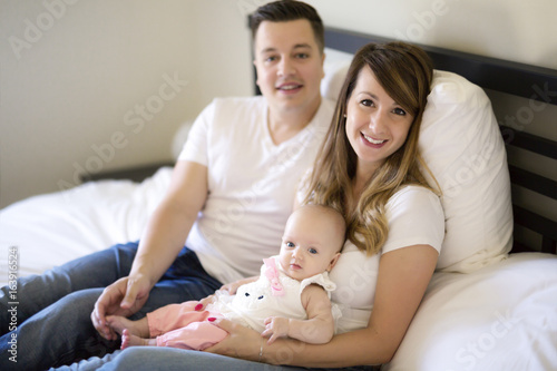 Portrait of parent with her 3 month old baby in bedroom