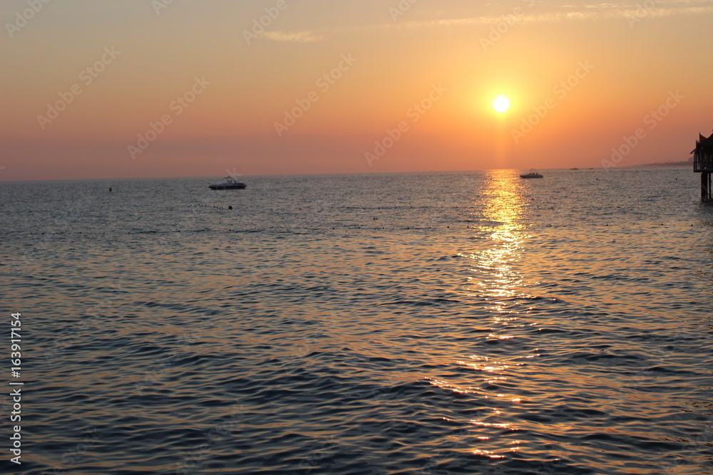 Fototapeta premium sunset on the beach, romantic time, lovelu sky, ocean, dusk, clouds, romantic, lovely , bridge, colors, 