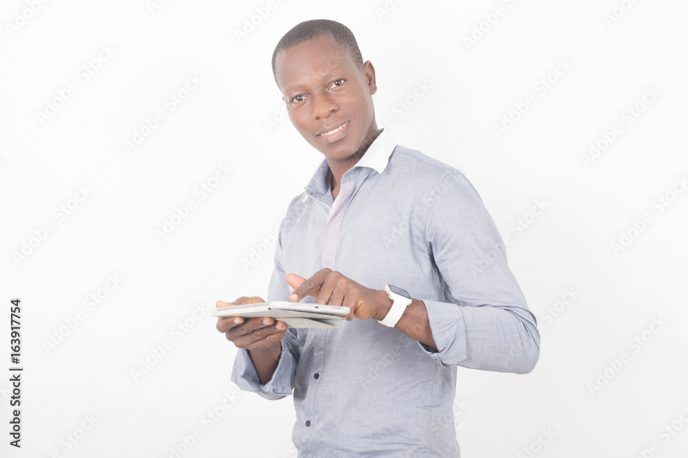 young businesswoman smiling and manipulating a digital tablet isolated on light background young businesswoman smiling and manipulating a digital tablet isolated on light background