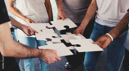 Bild auf Leinwand Team of businessmen work together for one goal