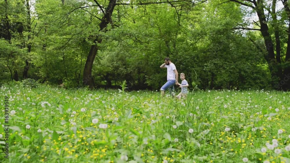 Young father with little boy in nature, sunny spring day. Young father with little boy in nature, sunny spring day.
