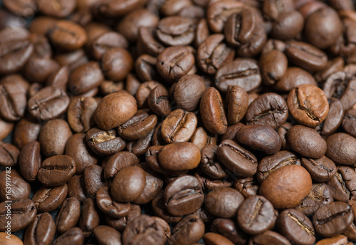 Roasted coffee beans on dark background. Selective focus.