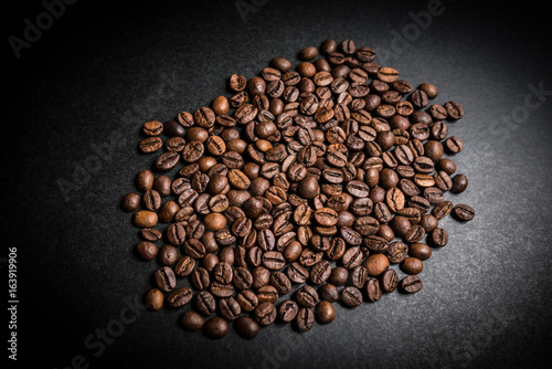 Roasted coffee beans on dark background. Selective focus. © Vladimir Arndt