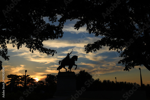 July 7  2017 - St. Louis  Missouri - The sunset over the Apotheosis of St. Louis statue of King Louis IX of France  namesake of St. Louis  Missouri in Forest Park  St. Louis  Missouri.