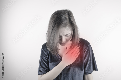 asian woman is clutching her chest. Heart disease. Acute pain possible heart attack. Healthcare, Medical and sickness concept