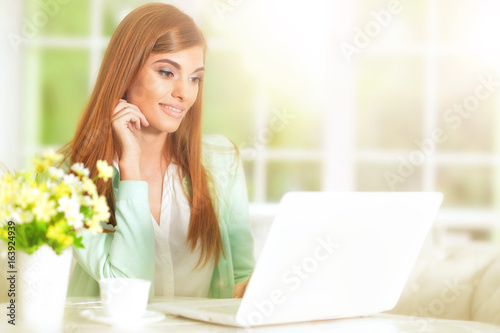 Beautiful young girl with a laptop