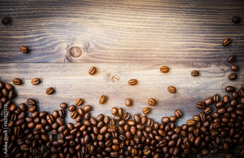 Peaberry coffee beans on wooden background photo