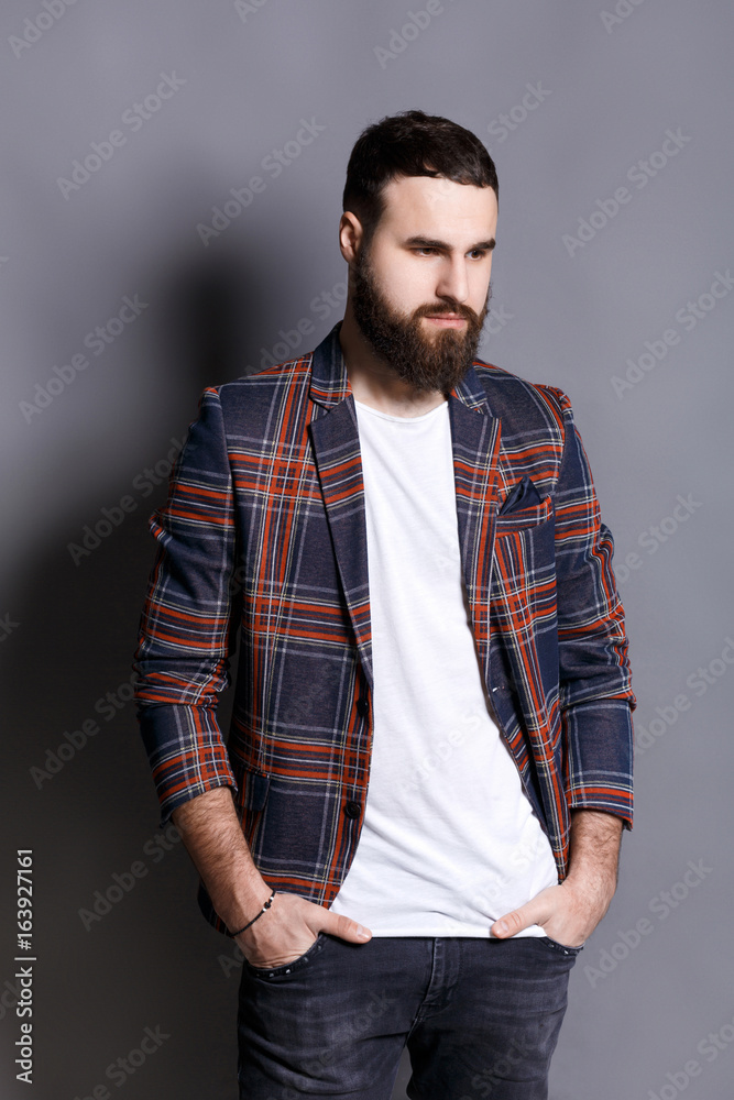 Handsome bearded man posing with hands in pocket Handsome bearded man posing with hands in pocket