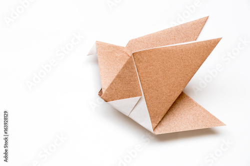 Brown origami paper in flying bird shape background