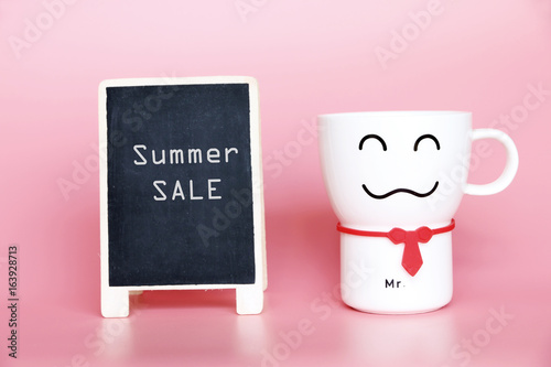 SUMMER SALE text on blackboard and Coffee cup smiling