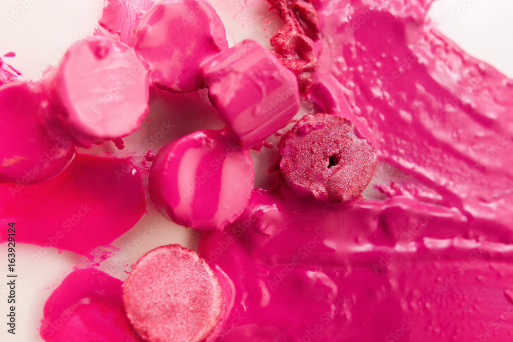 Pink lipstick chopped and melted on background. Cosmetics commercial, beautiful style closeup. Glamorous magazine, creative advertising, beauty concept Pink lipstick chopped and melted on background. Cosmetics commercial, beautiful style closeup. Glamorous magazine, creative advertising, beauty concept