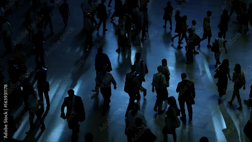 crowd of people walking on busy street commuting through the city metropolis 