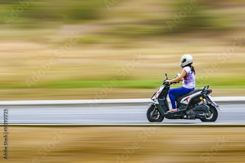 Adult Woman Driving Scooter at Outdoor