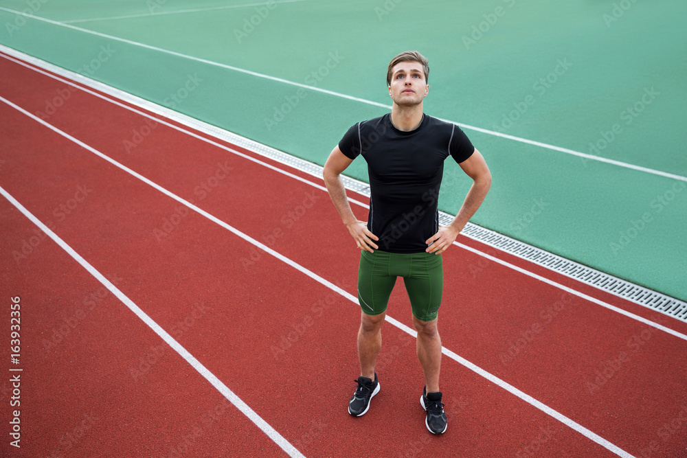 Attractive young male athlete standing outdoors