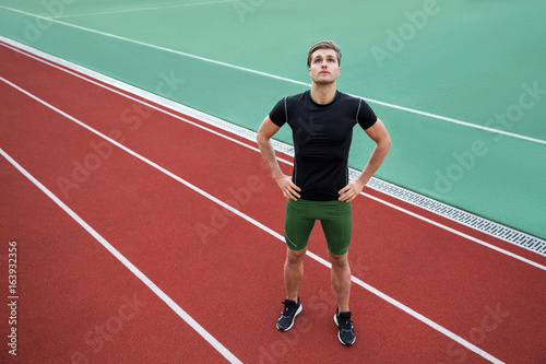 Attractive young male athlete standing outdoors © Drobot Dean