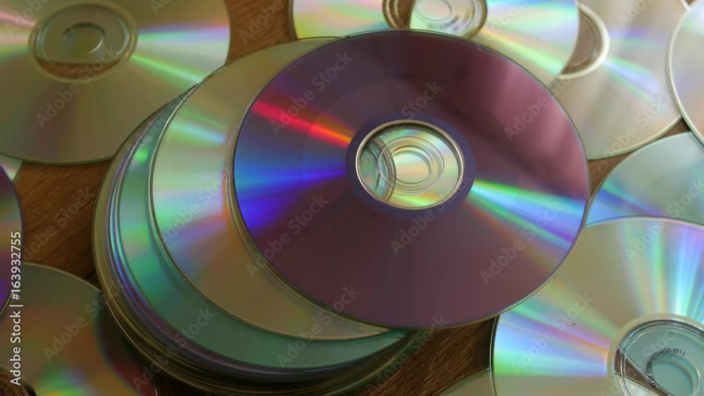 Optical Discs falling onto big pile of DVDs or CDs. Optical Discs falling onto big pile of DVDs or CDs.