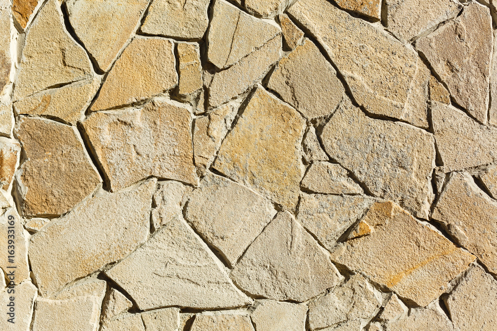 Fototapeta premium Multi-colored and multi-sized, orange and brown rock wall grunge texture background.