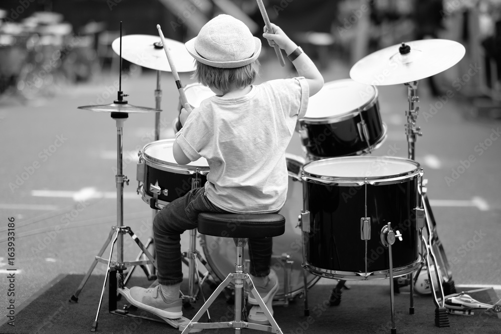 Fototapeta premium A little musician behind the drum set. Baltic Drum Summit 2017. Riga, Latvia.