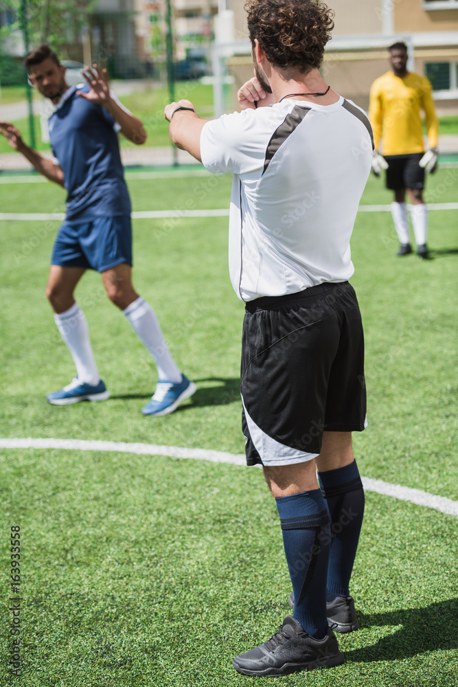 group of multiethnic soccer players during soccer match on pitch group of multiethnic soccer players during soccer match on pitch