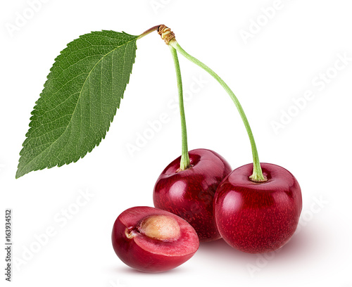 Sweet cherry berry. Two on a branch. One cut in half with bone.