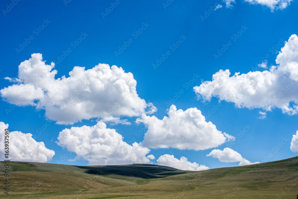 shadows of fluffy clouds over green hills at sunny day
shadows of fluffy clouds over green hills at sunny day