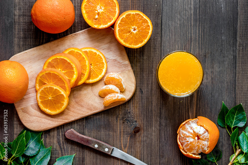 Citrus concept. Oranges, mandarins, fresh juice on wooden table background top view copyspace