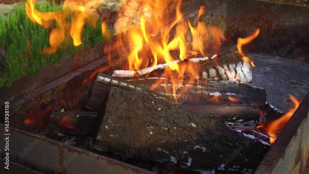 firewood burning in brazier outdoors