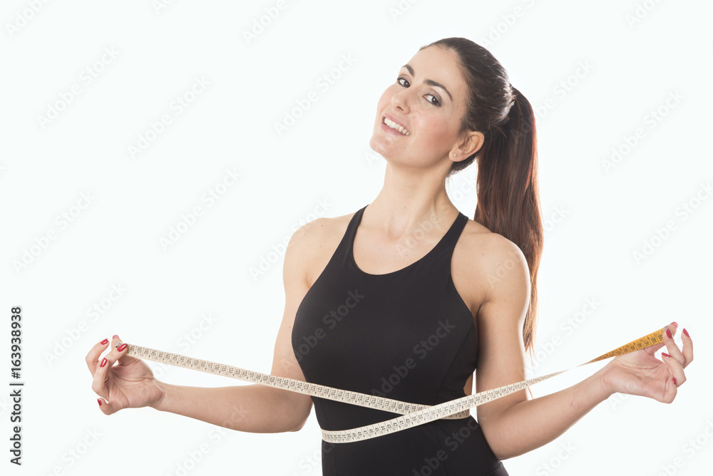 Young woman measuring waist with tape measure Stock Photo | Adobe Stock