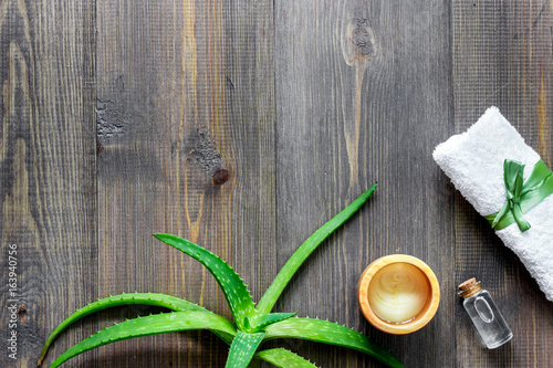 Skin care. Aloe vera gel and aloe vera leafs on wooden background top view copyspace