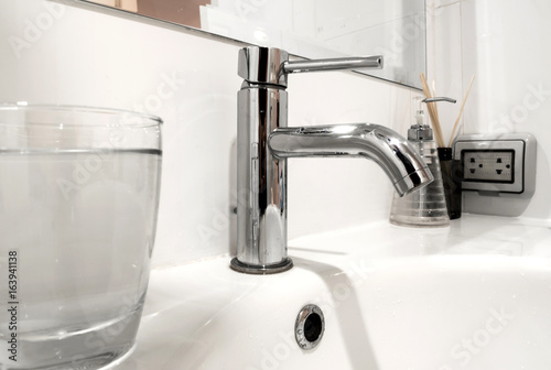 Bathroom faucet and wash basin with water glass