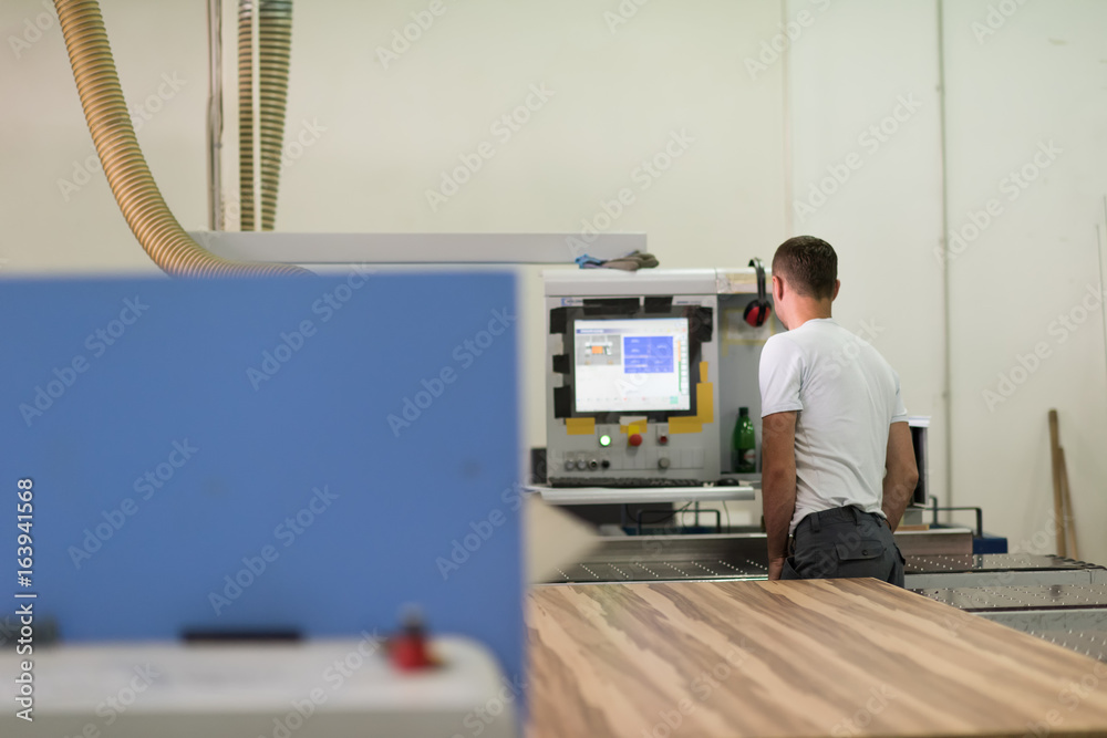 worker in a factory of wooden furniture worker in a factory of wooden furniture