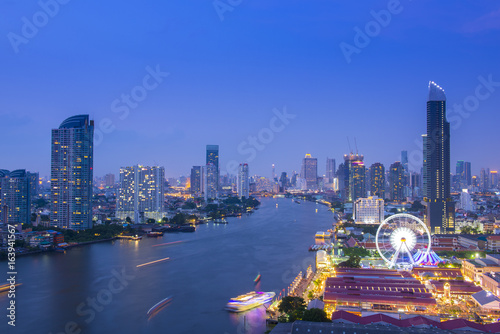 Bangkok city skyline at night. The Ferris wheel and shopping place are very famous location for tourist. This location is near by Chao Phraya river can access by shuttle boat and bus.