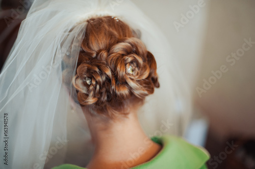 Hairstyle of the bride. Beautiful wedding hairstyle for the bride. Large with details
