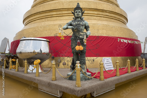 Bangkok,Thailand - May 2017 : A buddhist prays for blessings from Chedi Phukhao Thong (Golden Mount Pagoda) of Wat Saket temple. This enormous temple is one of the oldest temple in Bangkok,Thailand. photo