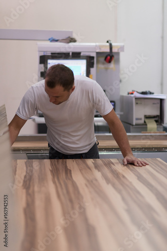 worker in a factory of wooden furniture
