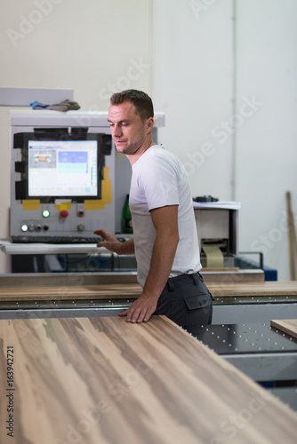 worker in a factory of wooden furniture