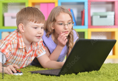  teenagers in front of modern laptop photo