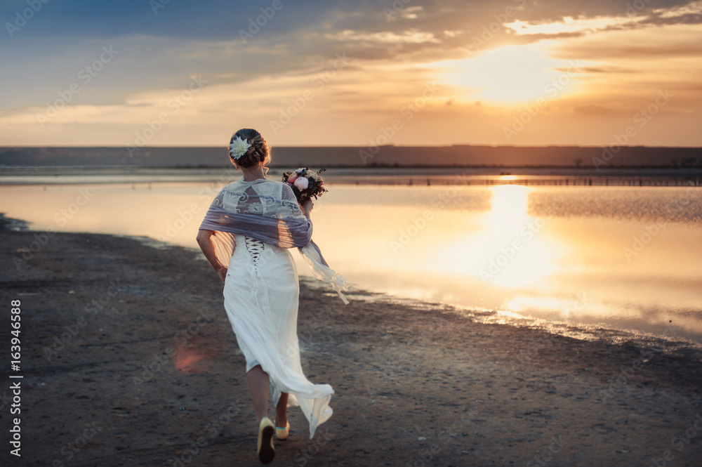 Wedding couple on a walk bride and groom sea field sunset architecture grass sand Wedding couple on a walk bride and groom sea field sunset architecture grass sand