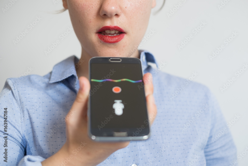 Woman talking on the phone with digital voice assistant - obrazy, fototapety, plakaty 