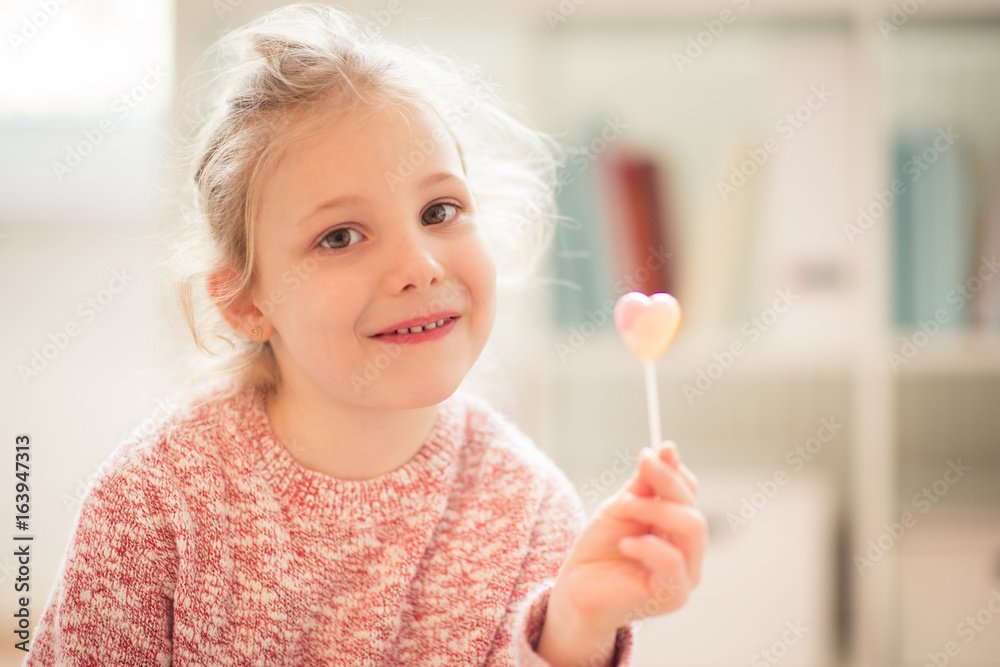 Portrait of happy child girl with lolipop in her hand Portrait of happy child girl with lolipop in her hand
